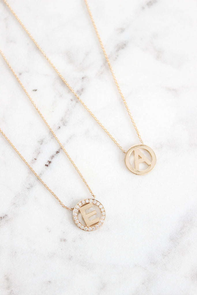 The 14K Adira Necklace is a minimal, yet bold way to wear your favorite letter. With or without diamonds, this necklace is a stunning piece to wear alone or layered.   Details:  Shown in 14K Yellow Gold Available in 14K Yellow Gold, 14K Rose Gold, 14K White Gold. The medallion measures 12 mm. The Adira with diamonds holds 0.18 ct.w. Please allow 2-3 weeks for production time. 