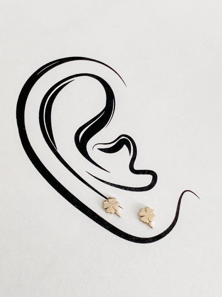 The 4 leaf clover earring worn on the ear.