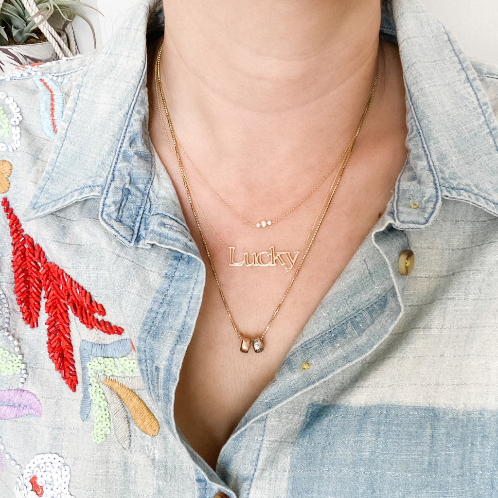 Layered with the Trio Necklace, and the personalized beads on the box chain.