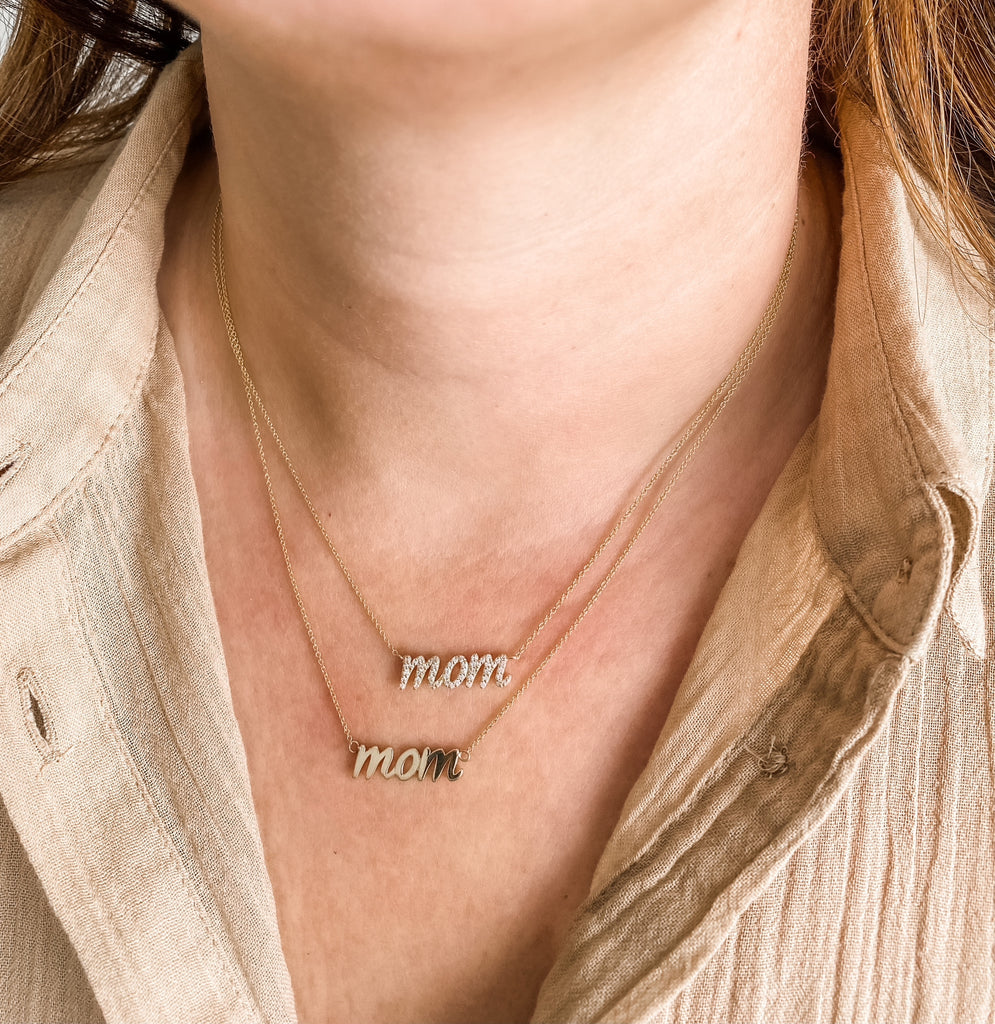 Shown here layered with the diamond and solid gold version of the cursive mom necklace. 