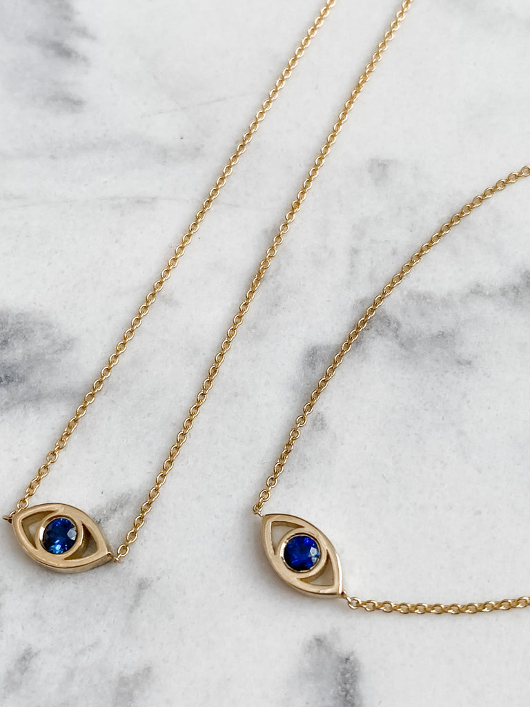 Blue Sapphires set into the bezels of the eye.