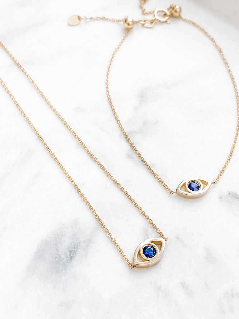The Lucky Eye bracelet and Necklace side by side. Both set with a Blue Sapphire.