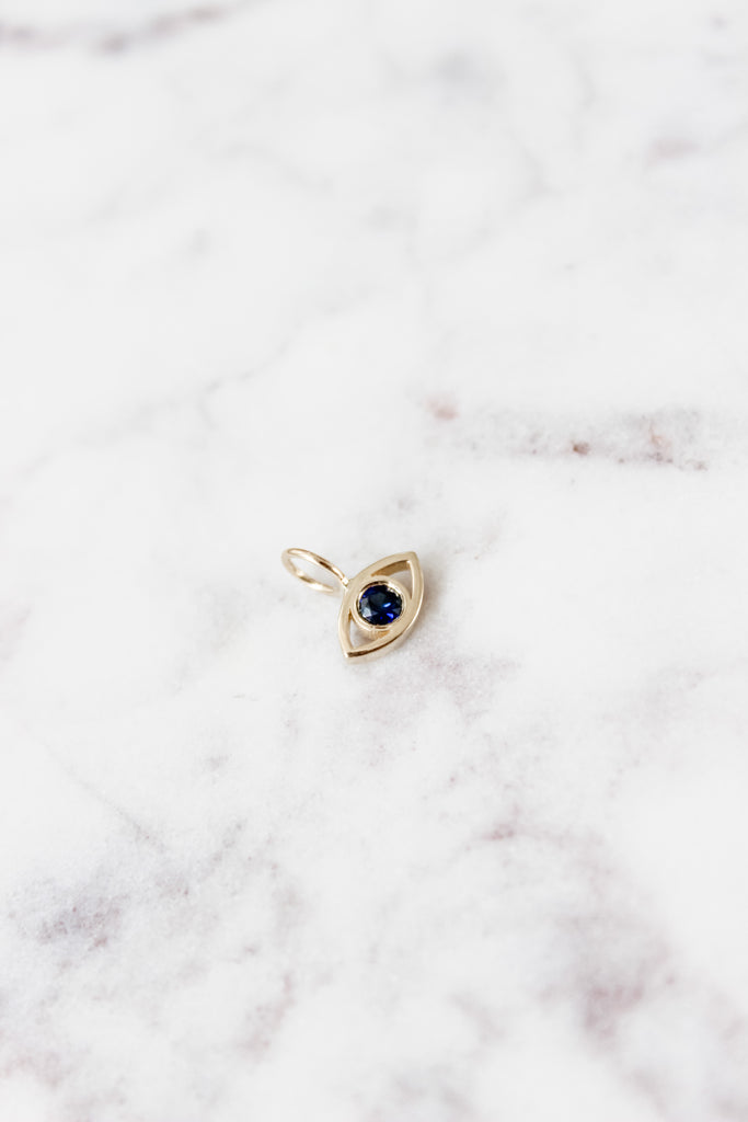 The Lucky Eye Charm in Yellow Gold and Blue Sapphire.